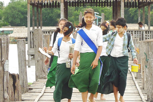 On the road: Girls walk to school over the U Bein Bridge in Amarapura.